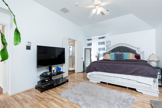 bedroom featuring ceiling fan, hardwood / wood-style floors, and vaulted ceiling