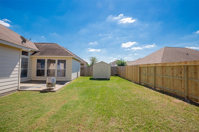 view of yard with a patio area and a storage shed