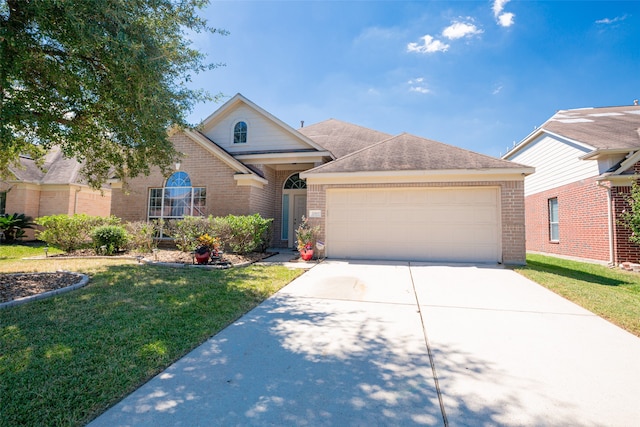 view of front of property with a garage and a front lawn