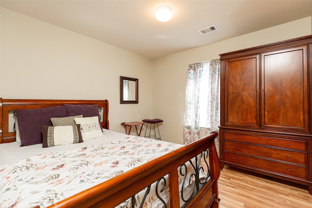 bedroom featuring a textured ceiling and light wood-type flooring