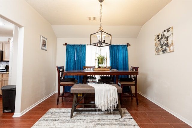 dining area with a notable chandelier, lofted ceiling, and dark wood-type flooring