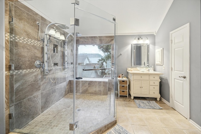 bathroom with tile patterned flooring, crown molding, lofted ceiling, vanity, and a shower with shower door