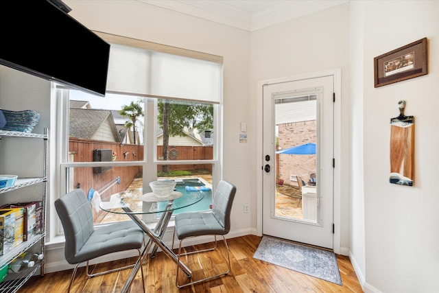 interior space featuring hardwood / wood-style flooring and crown molding