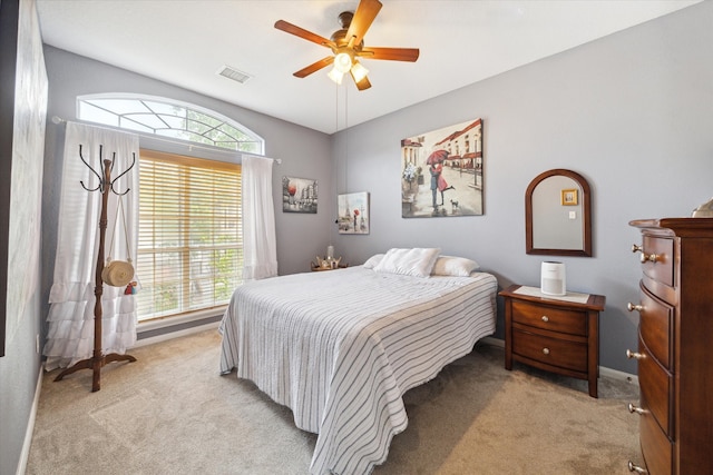 bedroom featuring light colored carpet and ceiling fan