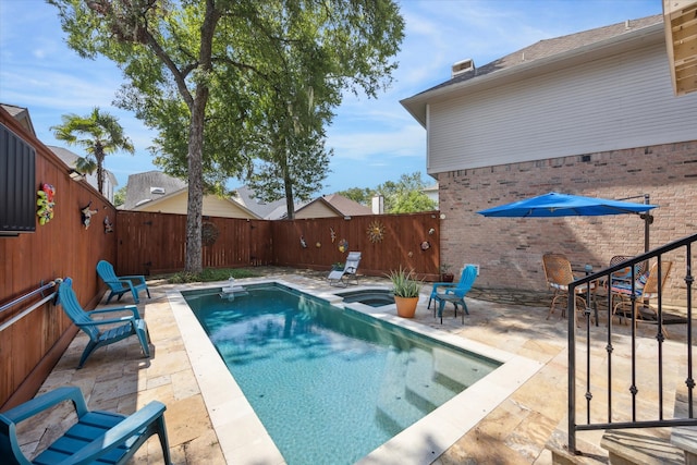 view of pool with a patio area and a hot tub