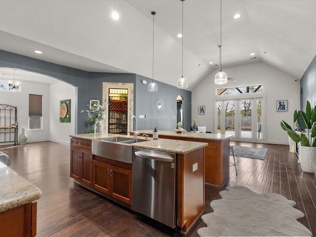 kitchen featuring dark hardwood / wood-style flooring, stainless steel dishwasher, a kitchen island with sink, hanging light fixtures, and lofted ceiling