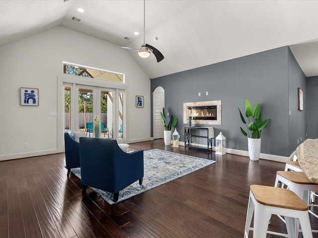 living room with ceiling fan, dark wood-type flooring, high vaulted ceiling, and french doors