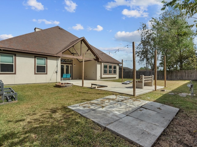 rear view of property with a lawn and a patio area