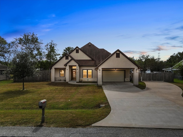 view of front of house featuring a garage and a lawn