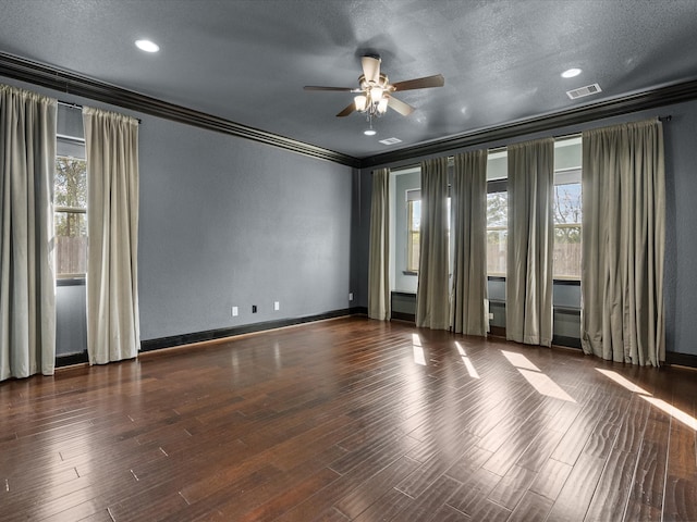 unfurnished room featuring ceiling fan, dark hardwood / wood-style flooring, ornamental molding, and a textured ceiling