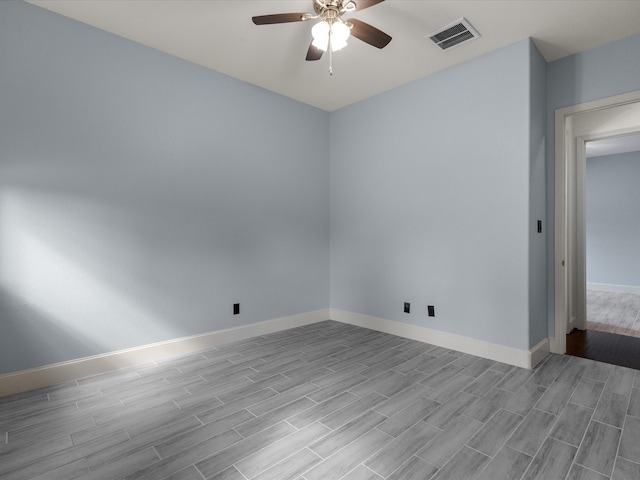 empty room with ceiling fan and light wood-type flooring