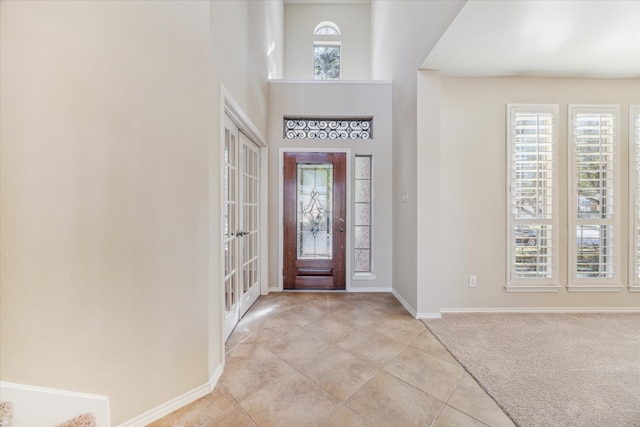 carpeted entryway featuring french doors