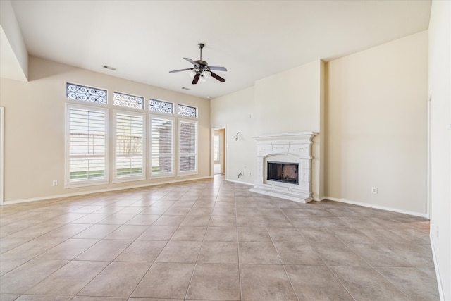 unfurnished living room with ceiling fan and light tile patterned floors