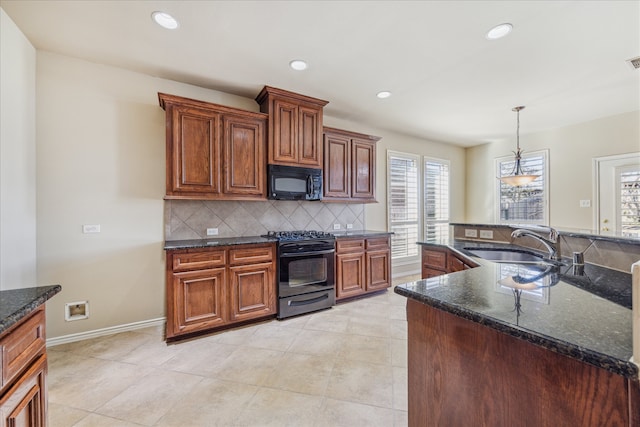 kitchen with black appliances, decorative backsplash, sink, and dark stone counters