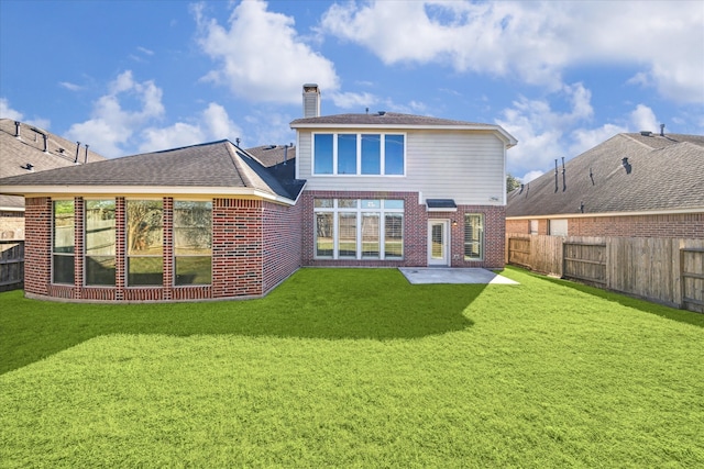 back of house featuring a lawn and a patio