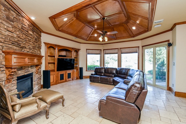 living room with a stone fireplace, plenty of natural light, and crown molding