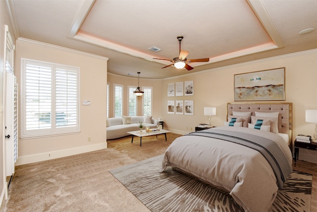 bedroom with ornamental molding, a textured ceiling, a raised ceiling, ceiling fan, and carpet floors