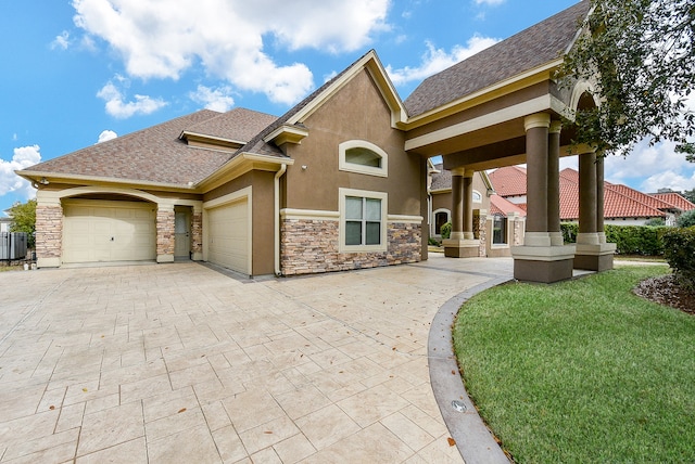 view of front of house with a garage and a front lawn