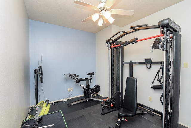 exercise room with ceiling fan and a textured ceiling