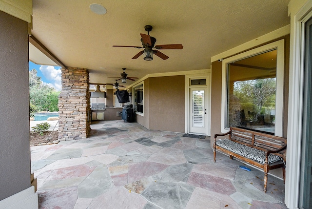 view of patio / terrace featuring ceiling fan and exterior kitchen