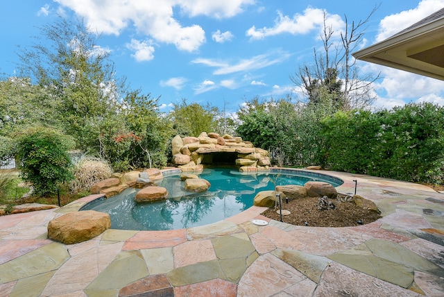 view of pool featuring a hot tub and a patio area