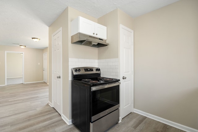 kitchen featuring white cabinetry, stainless steel electric range oven, a textured ceiling, decorative backsplash, and light wood-type flooring