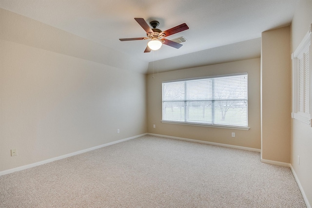 carpeted spare room featuring ceiling fan