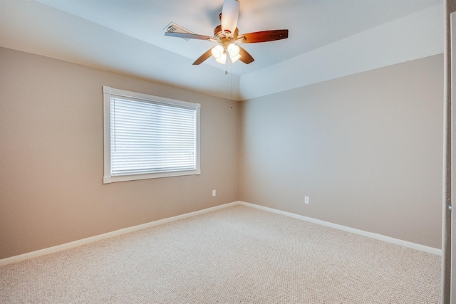 spare room featuring carpet, ceiling fan, and lofted ceiling