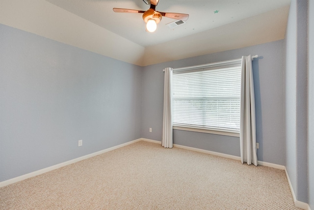 unfurnished room featuring light carpet, ceiling fan, and vaulted ceiling