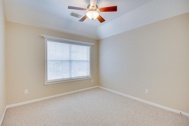 empty room featuring carpet, ceiling fan, and vaulted ceiling