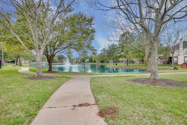 view of community featuring a yard and a water view