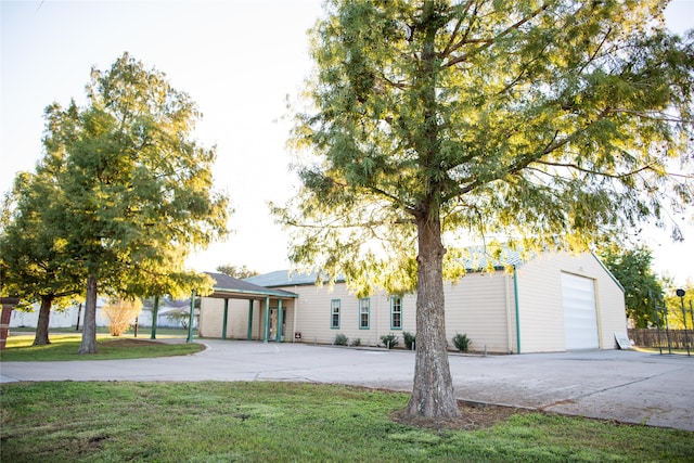 view of front of home featuring a garage and a front lawn