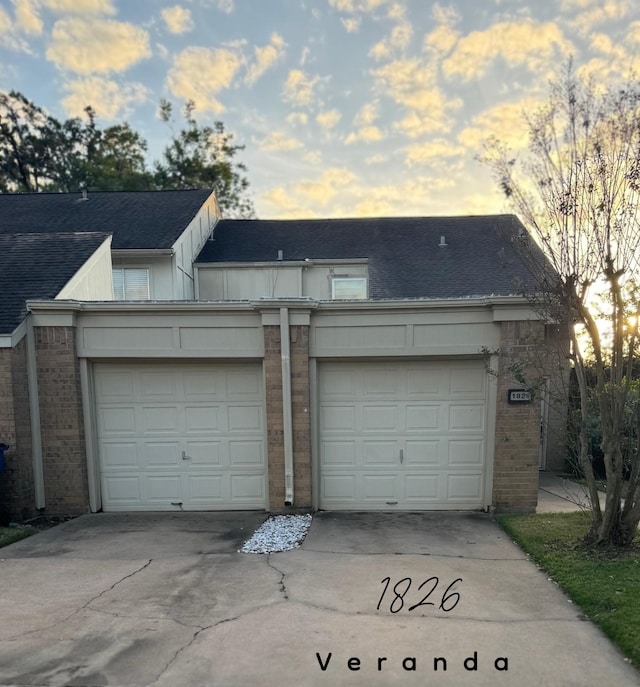 view of garage at dusk