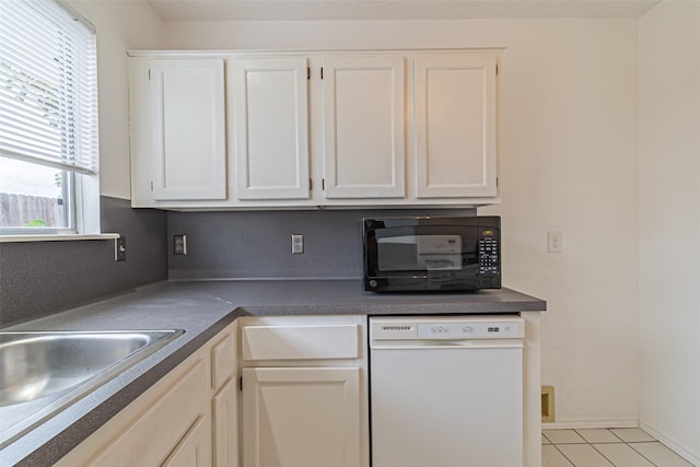 kitchen with white cabinetry, sink, and white dishwasher