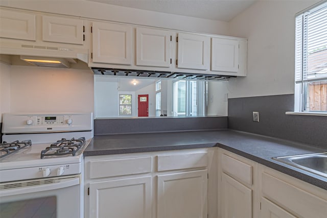 kitchen featuring sink, white cabinetry, and white gas range oven