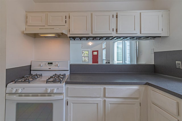 kitchen featuring white gas range and white cabinetry