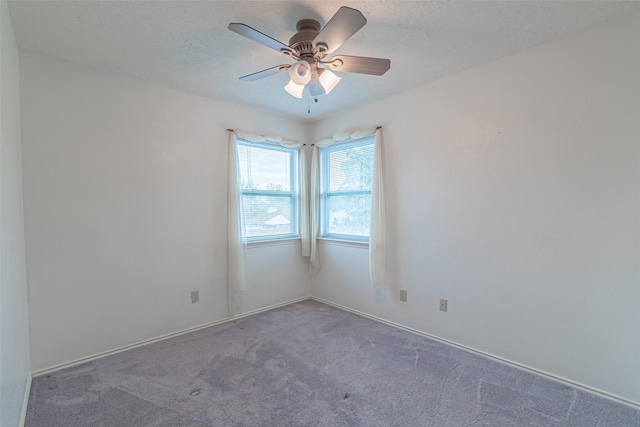 unfurnished room featuring a textured ceiling, carpet flooring, and ceiling fan