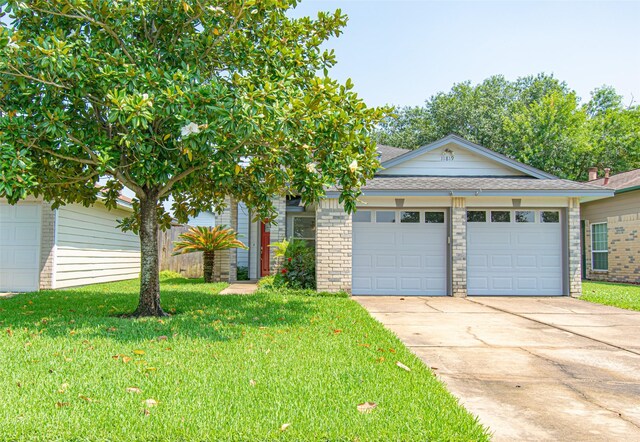 view of front of home with a front yard and a garage