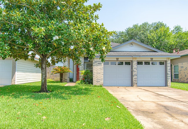 view of front of house with a garage and a front lawn