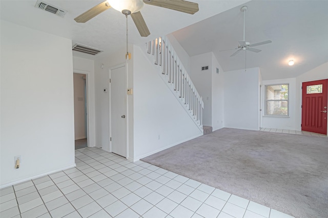 unfurnished living room with lofted ceiling, ceiling fan, and light colored carpet