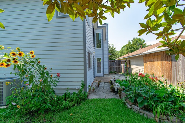 view of property exterior with central AC and a patio