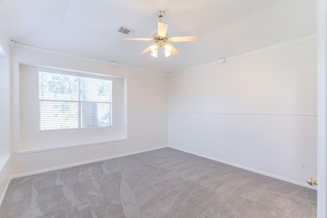 carpeted empty room with ceiling fan and crown molding