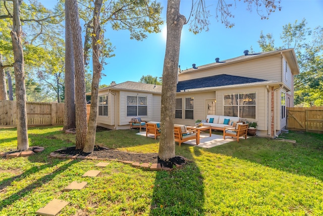 rear view of property featuring outdoor lounge area, a patio area, and a lawn