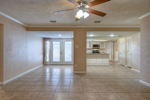 interior space featuring a textured ceiling, ceiling fan, crown molding, and french doors