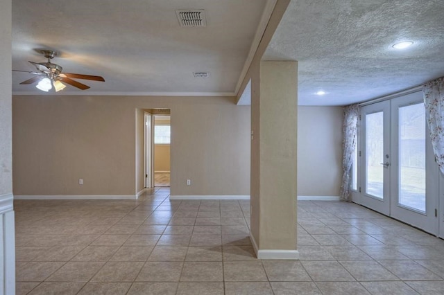 tiled spare room with ceiling fan, ornamental molding, a wealth of natural light, and french doors