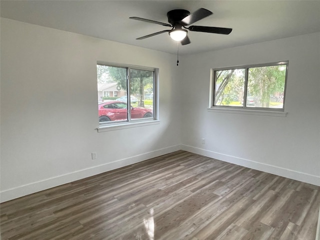 empty room featuring ceiling fan and hardwood / wood-style flooring