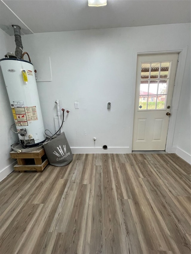 clothes washing area with hookup for a washing machine, gas water heater, and hardwood / wood-style flooring