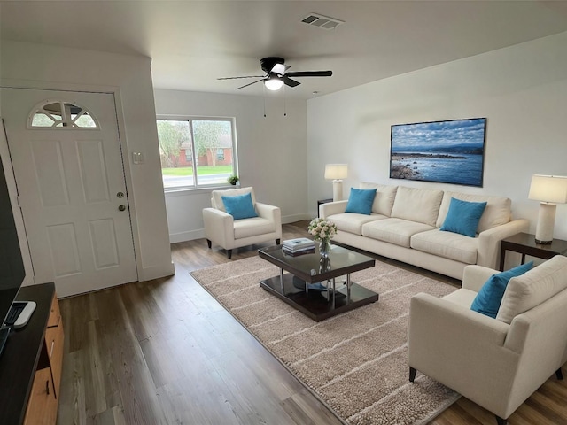 living room with wood-type flooring and ceiling fan