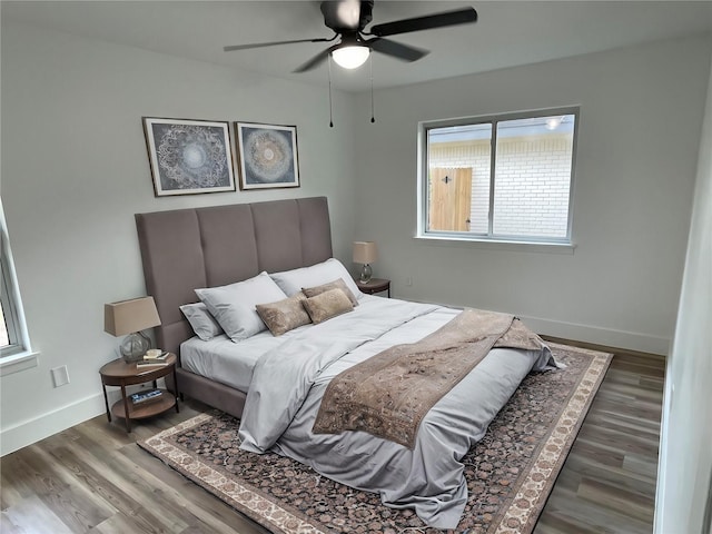 bedroom with ceiling fan and dark hardwood / wood-style flooring