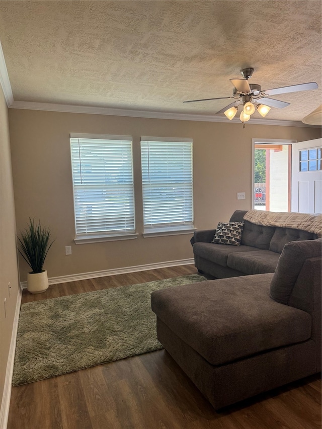 living room with hardwood / wood-style floors, ceiling fan, crown molding, and a textured ceiling